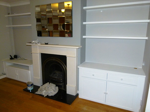 Elegant fitted alcove media cabinet with custom shelving and premium finish